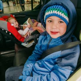 Two kids dressed safely in the car 