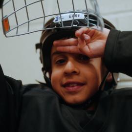 young boy in hockey helmet