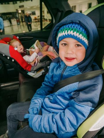 Two kids dressed safely in the car 