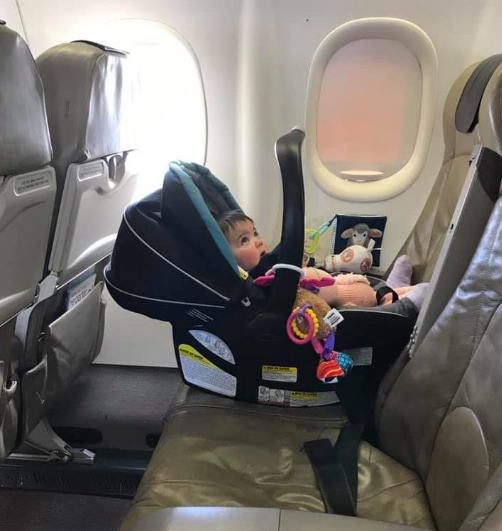 baby on plane in car seat