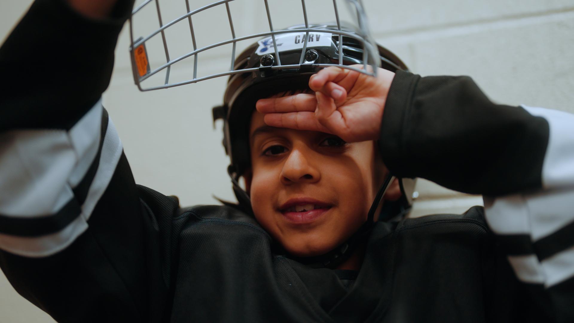 young boy in hockey helmet